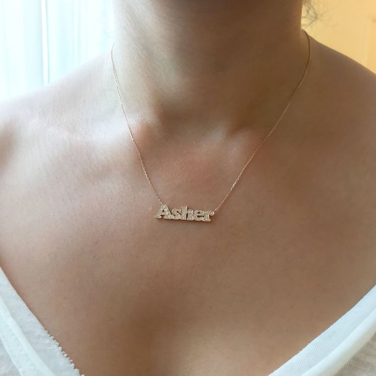 "This unique personalized block font single name cut-out necklace is composed of 14K solid gold and beautifully finished with pavé set genuine GVs1 quality natural real Diamonds covering the entire surface. This pendant is complemented by a durable 14K solid gold adjustable 16 to 18 inch chain. NOTE: The item will be made in the exact casing of the characters entered. Please be mindful of this detail when providing the customization desired. * This item can be purchased as a charm alone without Custom Name Fine Jewelry Nameplate Necklace, Custom Nameplate Necklace In Fine Jewelry Style, Custom Name Necklace In 14k Gold, Custom Name 14k Gold Name Necklace, Custom Name 14k Gold Necklace, Block Fonts, Block Font, Solid Gold Necklace, White Gifts