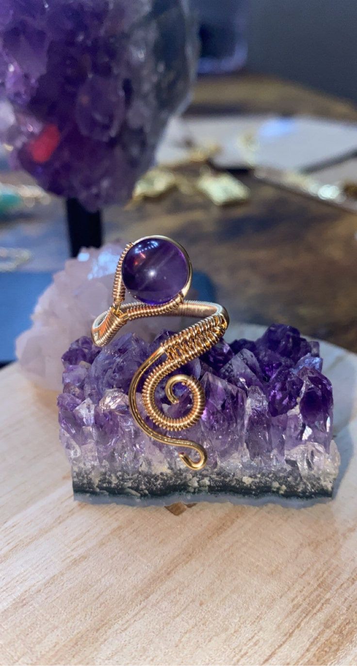 Amethyst bead with wire wrapped ring base Mystical Round Wire Wrapped Jewelry, Handmade Gold Amethyst Ring, Hand Wrapped Purple Round Jewelry, Hand Wrapped Round Purple Jewelry, Adjustable Spiritual Amethyst Ring With Natural Stones, Adjustable Amethyst Crystal Ring With Natural Stones, Spiritual Amethyst Ring For Jewelry Making, Hand Forged Adjustable Purple Jewelry, Adjustable Hand Forged Purple Jewelry