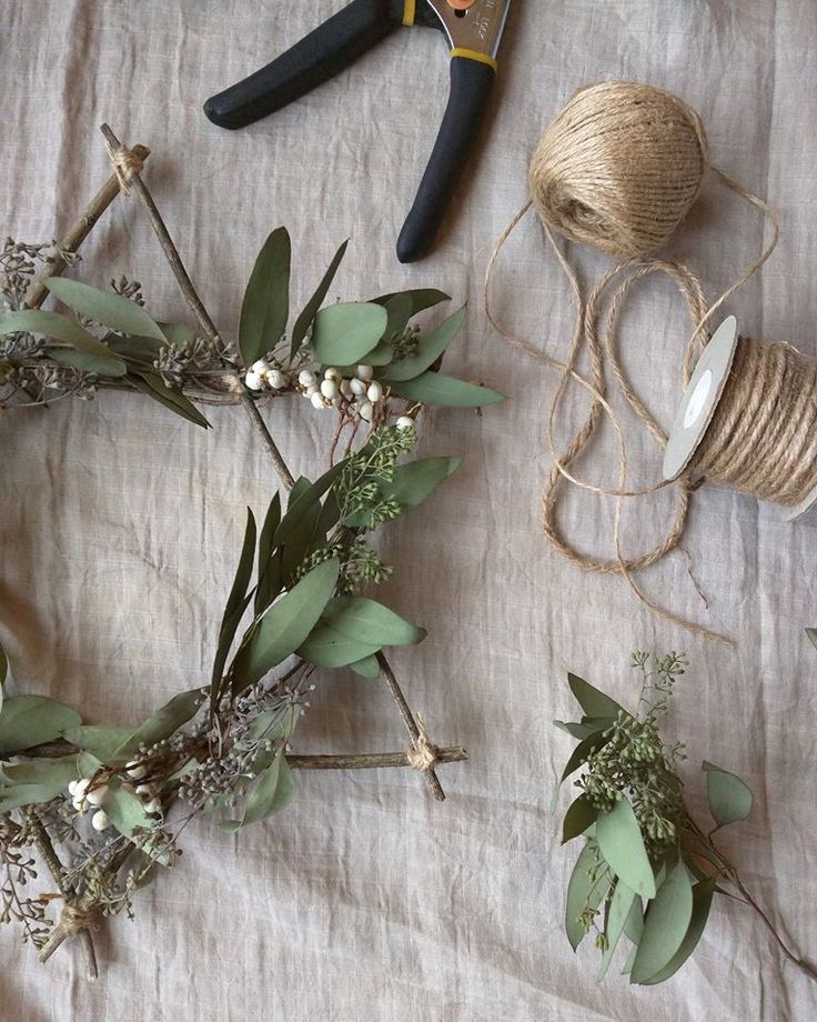 some flowers and scissors are laying on a table with yarn, twine and thread