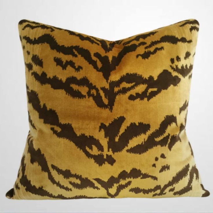 a brown and black pillow with an animal print pattern on it's front side