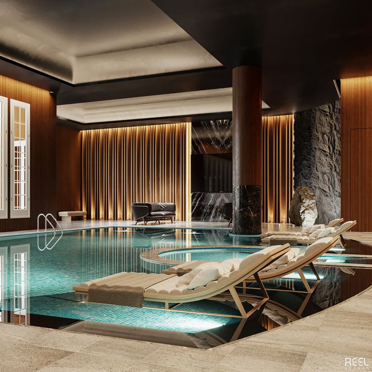 an indoor swimming pool with chaise lounges in the middle and windows on either side