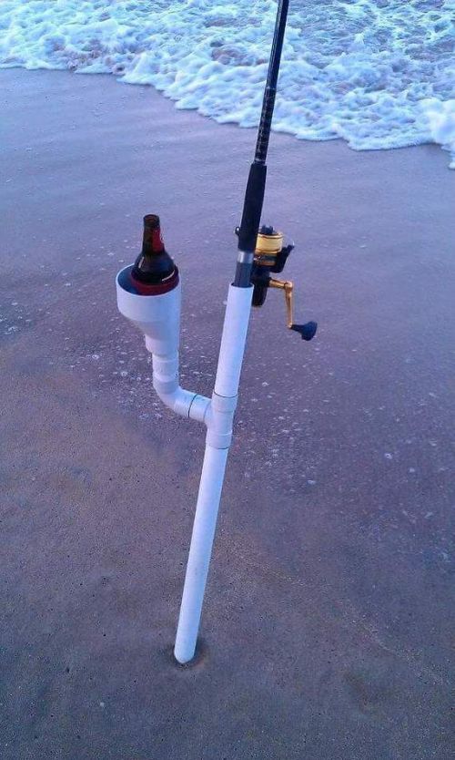 a fishing pole sticking out of the sand