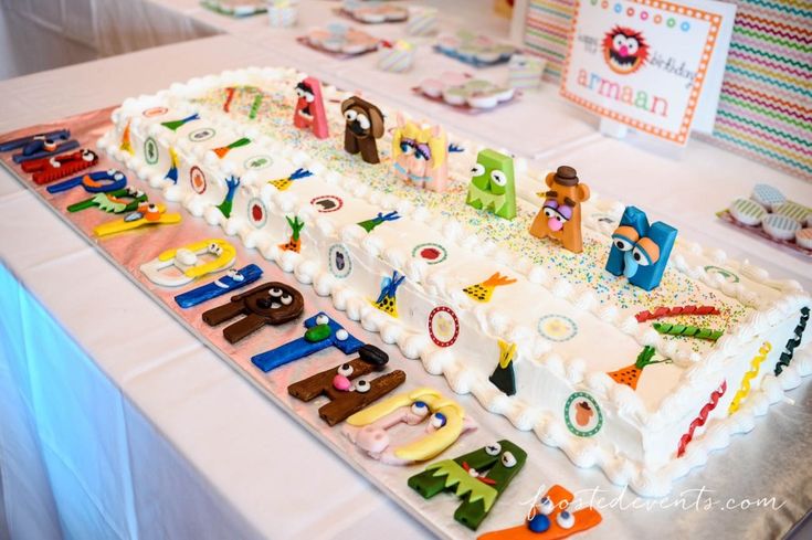 there is a very large cake on the table with many letters and numbers around it