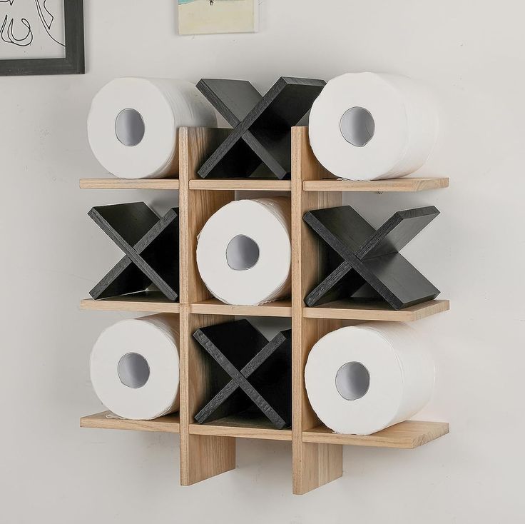 several rolls of toilet paper are stacked on wooden shelves