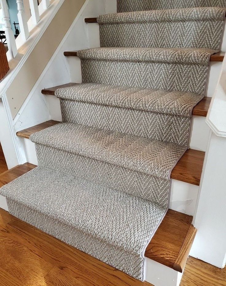 a set of stairs with carpeted treads in a home