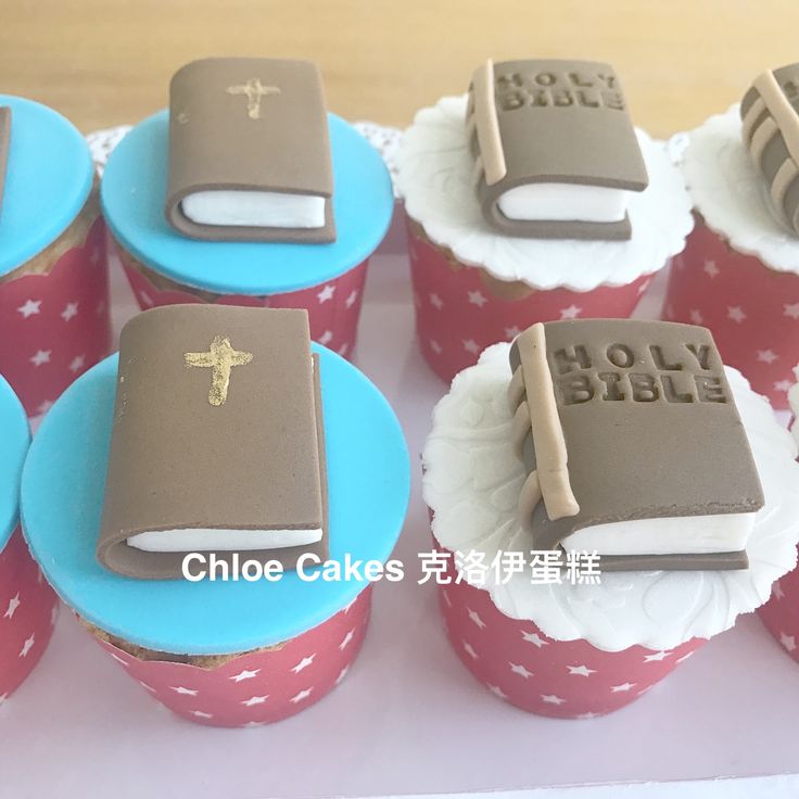 cupcakes decorated like bible books on red and blue paper with white frosting