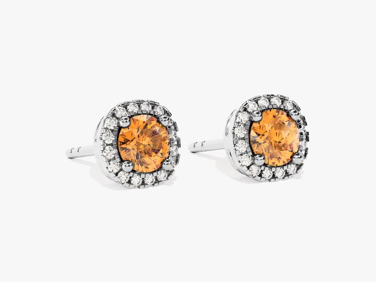 The central stone is a captivating citrine gem with its warm and inviting golden-orange hue. Citrine is known for its vibrant and uplifting energy, resembling the glow of the sun. The central citrine gem in this citrine earrings is encircled by a halo of smaller, sparkling diamonds. This design enhances the brilliance of the centerpiece and adds a touch of glamour to your ensemble. Classic Orange Jewelry As Gift, Classic Orange Jewelry For Gift, Fine Jewelry Topaz With Halo Design, Orange Gemstone Jewelry For Formal Occasions, Formal Orange Gemstone Jewelry, Classic Citrine Jewelry With Halo Setting, Orange Topaz Birthstone Jewelry, Orange Citrine Jewelry With Polished Finish, Elegant Citrine Jewelry With Halo Setting