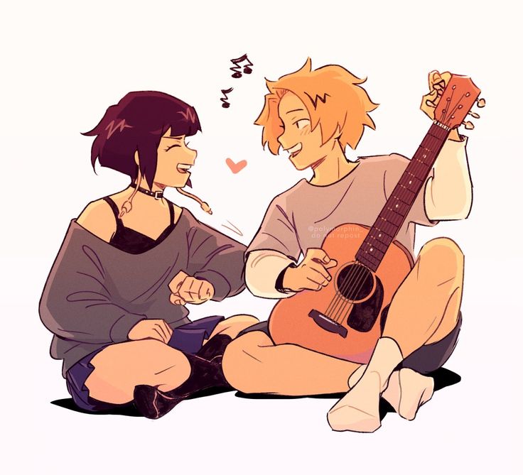 two people sitting next to each other holding guitars