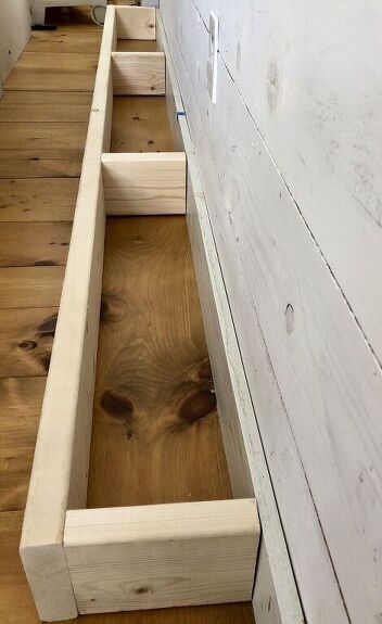 an unfinished bench is sitting on the floor