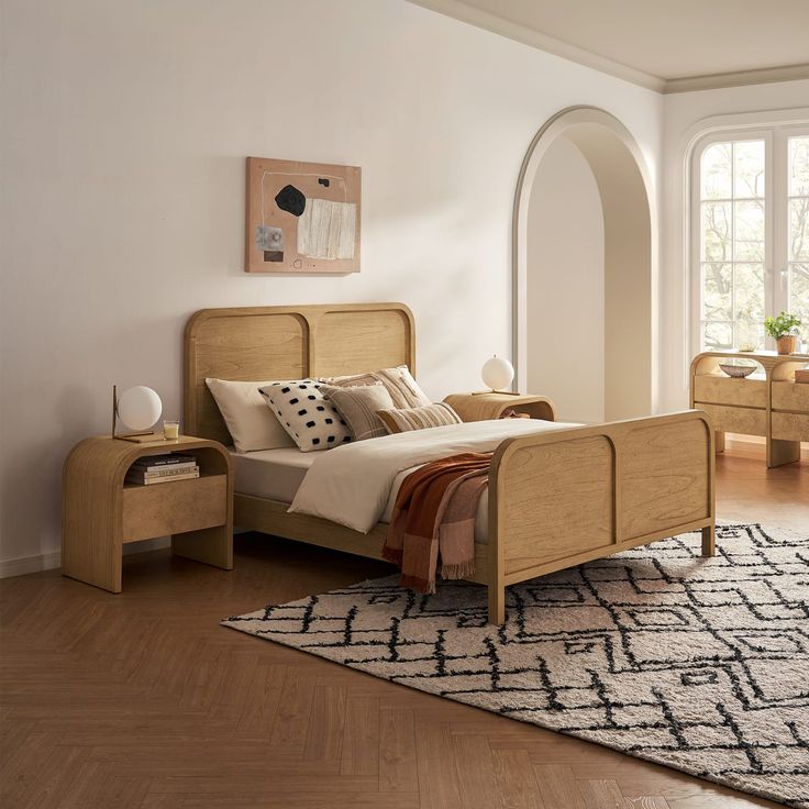 a bed room with a neatly made bed and a rug on the floor next to it