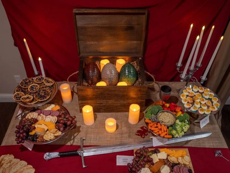 a table topped with lots of food and candles