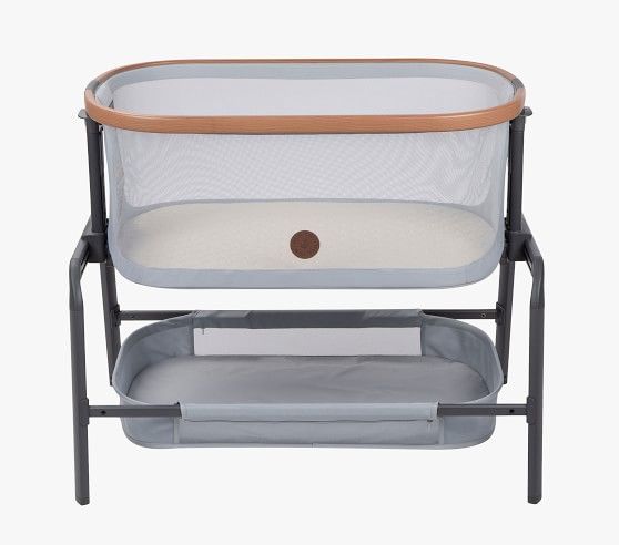 a baby crib that is sitting up against a white background