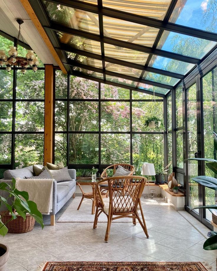 a living room filled with furniture and lots of glass walls on top of each other