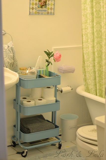 a bathroom with a toilet, sink and bathtub in it's center area