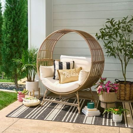 The Better Homes & Gardens Bellamy Round Wicker Outdoor Egg Chair is sure to elevate your relaxation experience. The Better Homes & Gardens Bellamy Round Wicker Outdoor Egg Chair is designed to cradle you in luxurious comfort. Handwoven from durable and weather-resistant wicker, durable Fabric of high quality on our egg chair is perfect for both indoor and outdoor settings. Sink into the plush cushions, designed for hours of cozy lounging, while the chic, contemporary design adds a touch of eleg Egg Furniture, Outdoor Stacking Chairs, Outdoor Wicker Chairs, Basket Chair, Boho Patio, Diy Porch, Chair And Ottoman Set, Porch Garden, Better Homes And Garden