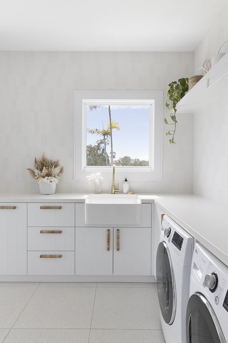 a washer and dryer in a white kitchen