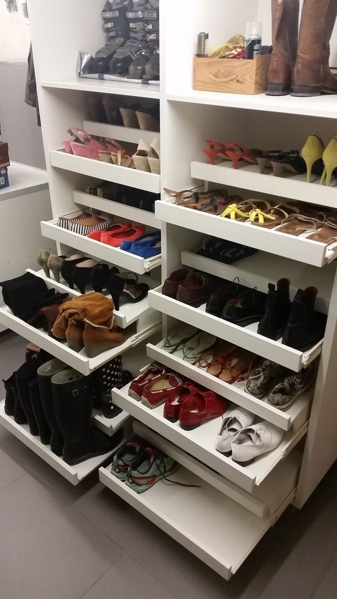 the shoe rack is full of shoes for all kinds of people to choose between them