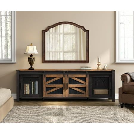 a living room with a couch, chair and large mirror on it's wall