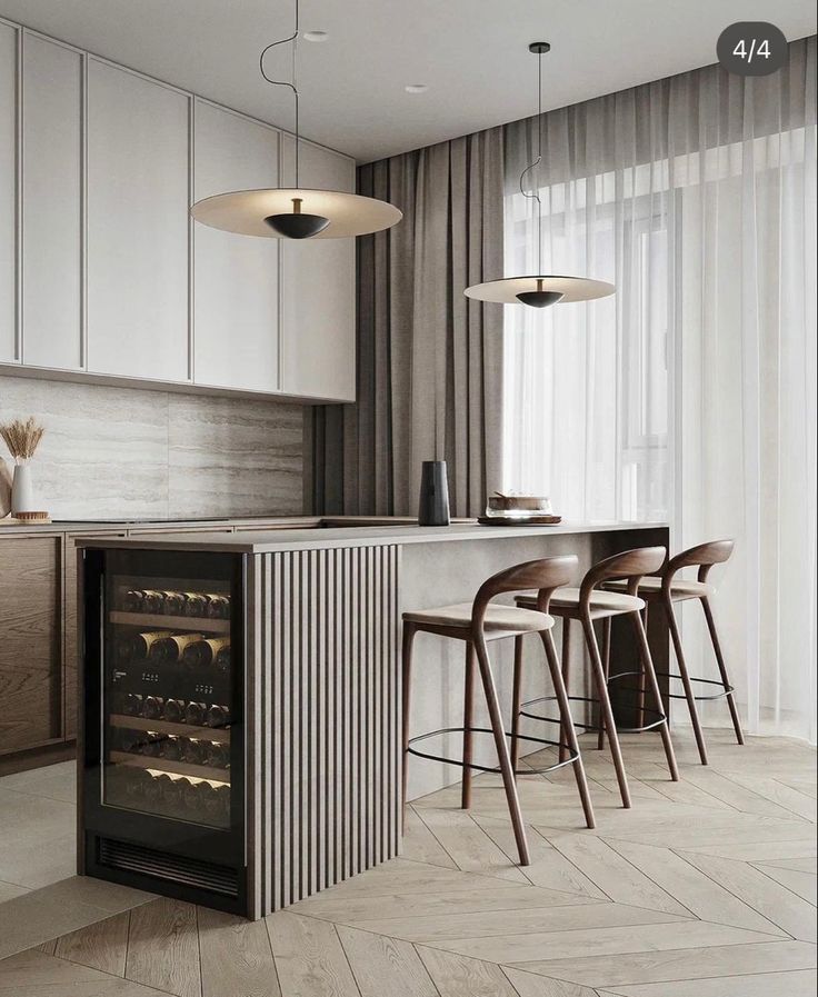 a modern kitchen with white cabinets and bar stools