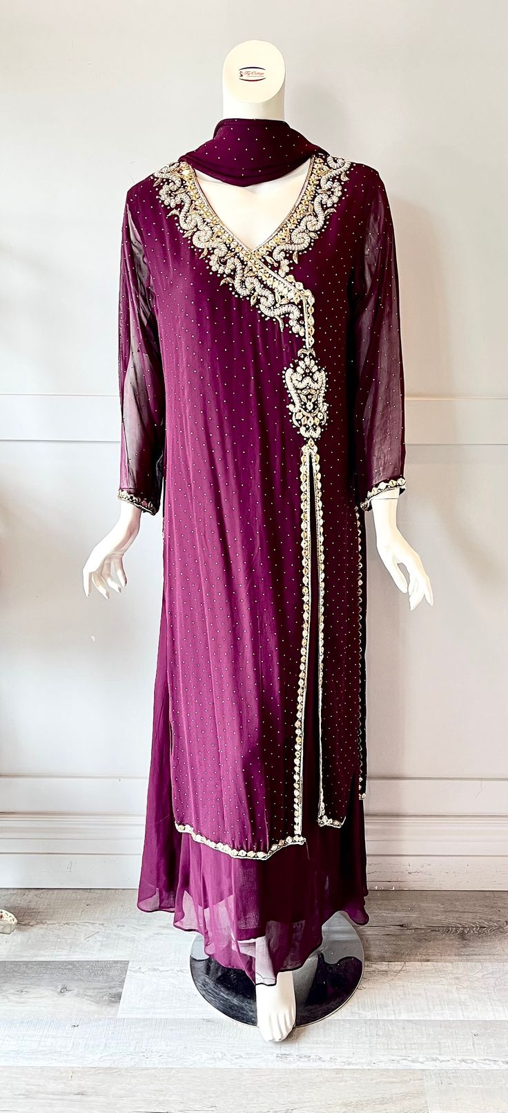 Fabric: Georgette  Color: purple  Embroidery: Rhinestones with crystals and golden thread embroidery  Size:- Medium (42), Large (44), X-Large(46) Full length: 58" Elegant Georgette Kaftan For Reception, Floor-length Georgette Kaftan For Reception, Elegant Georgette Kaftan With Mirror Work, Evening Georgette Kaftan With Zari Work, Anarkali Gown With Stone Work Floor-length, Evening Kaftan With Zari Work In Georgette, Formal Party Gown With Dabka Work, Semi-stitched Festive Dress With Stone Work, Floor-length Georgette Kaftan With Zari Work