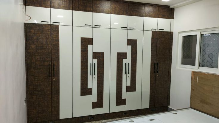 an empty room with white and brown cabinets