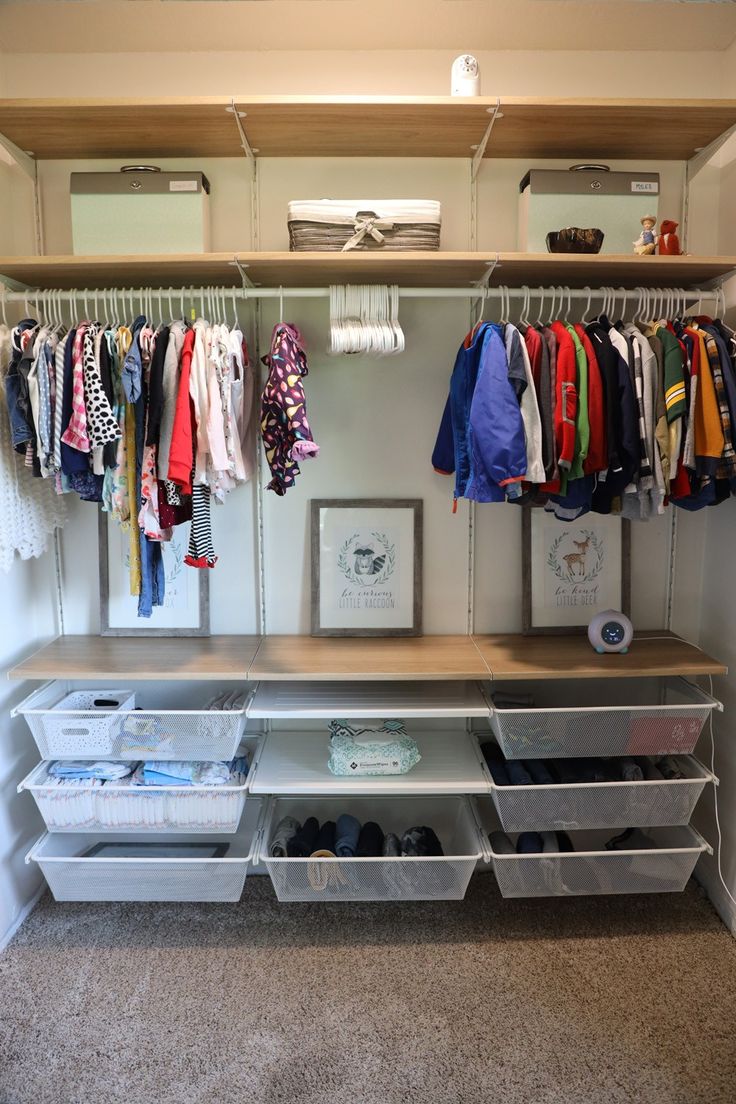 an organized closet with clothes and shoes hanging on the rack, along with other storage bins