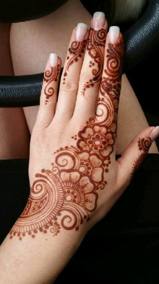 a woman's hand with henna tattoos on it