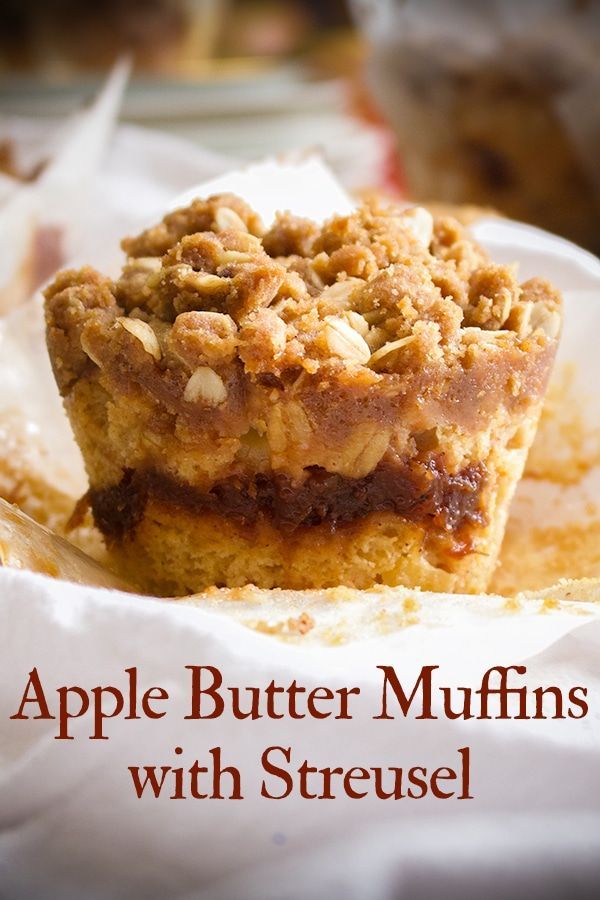 two pieces of apple butter muffins with streuse sitting on top of each other