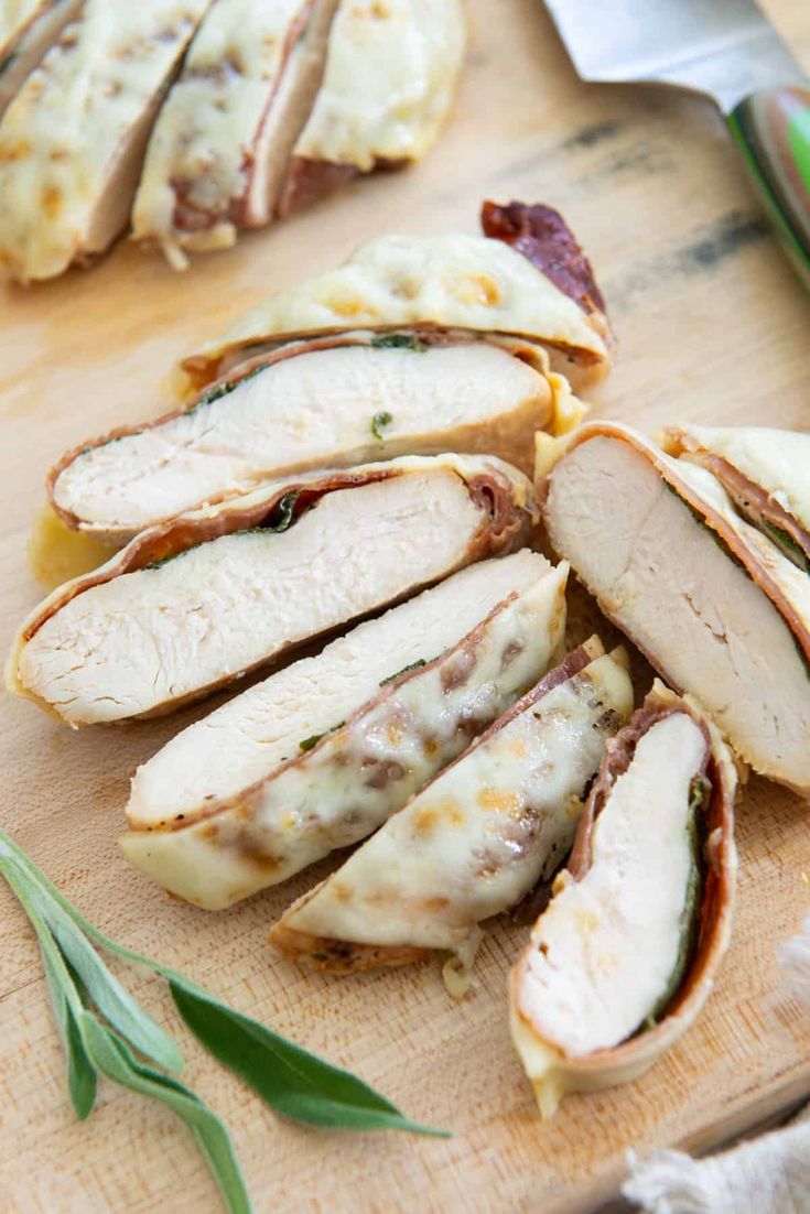 sliced chicken on a cutting board next to a knife