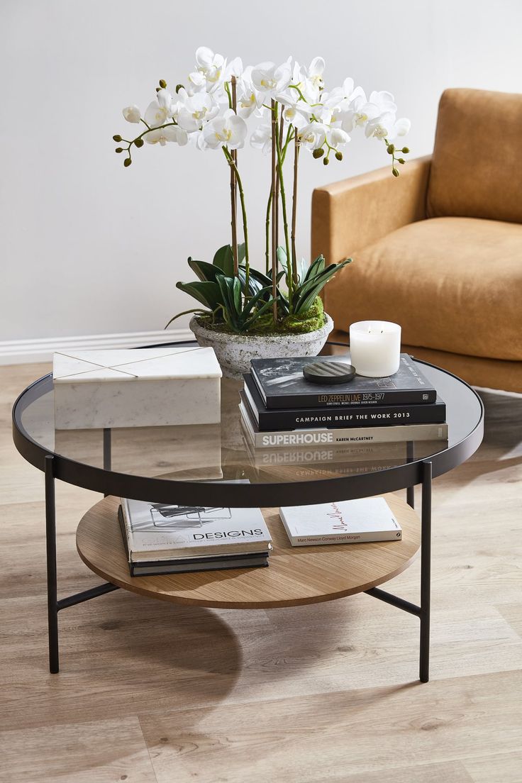 a coffee table with flowers and books on it