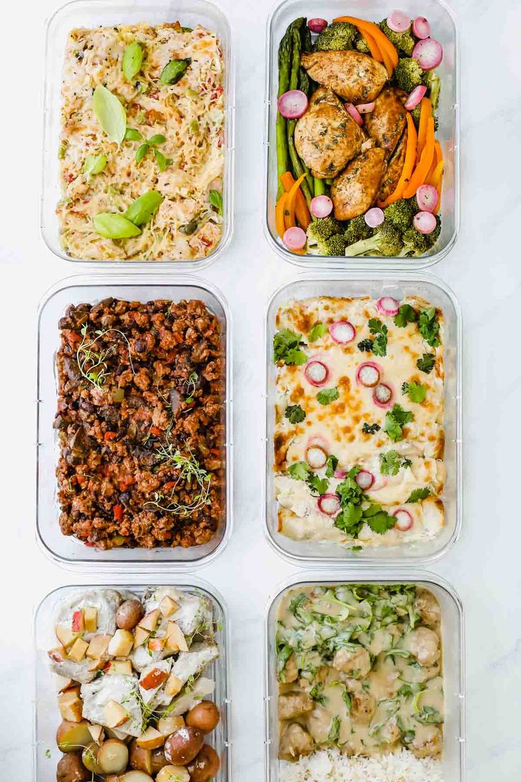 four plastic containers filled with different types of food