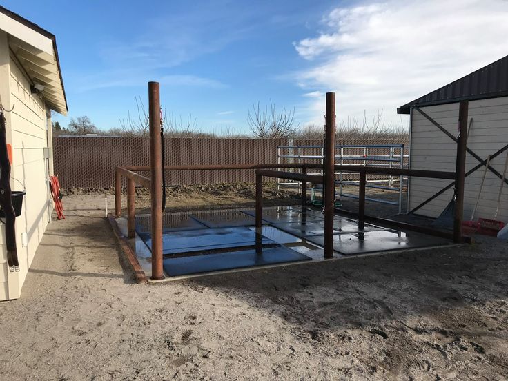 a building with a metal fence in front of it and some snow on the ground