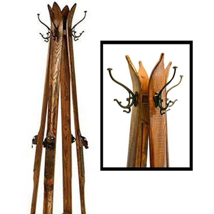 a wooden coat rack with two skis on it's sides and one standing upright