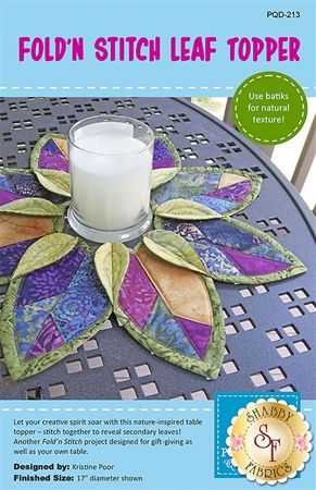 an advertisement for a table with a candle on it and a flower design in the center