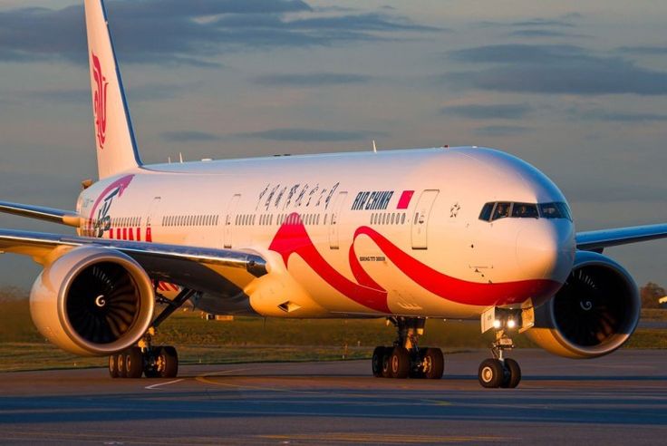 an airplane that is sitting on the tarmac at sunset or dawn, with it's landing gear down