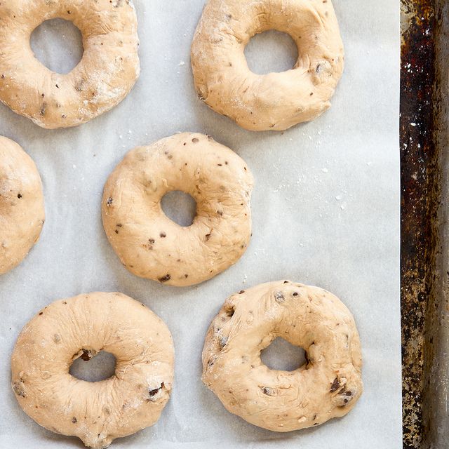 six bagels on a baking sheet ready to be baked