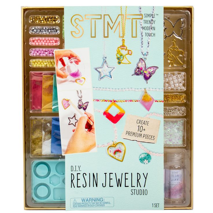 an assortment of jewelry and crafting supplies in a wooden box with the words stmt on it