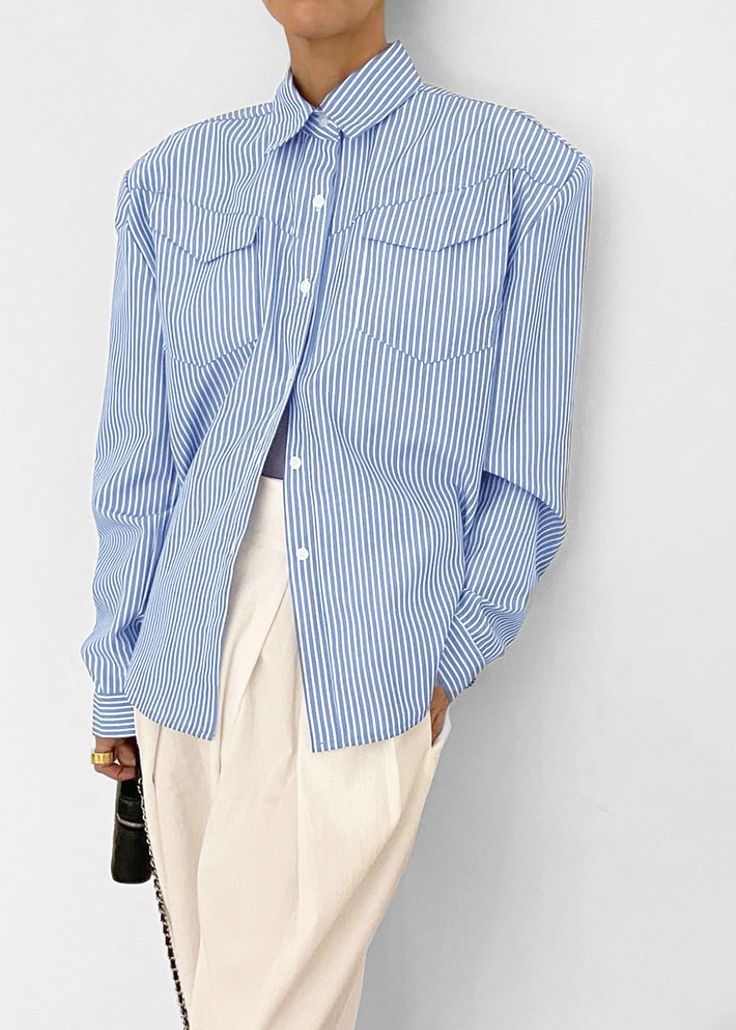 Color: White Stripe Crisp woven shirting fabric Relaxed fit Padded shoulders Pointed collar Flap breast pockets Button cuffs Curved hem Button front closure 80% Polyester 20% Cotton Imported Product Measurements: S- 20" Shoulder, 44" Bust, 26" Length M- 20.5" Shoulder, 46" Bust, 26.5" Length L- 21" Shoulder, 48" Bust, 27" Length Model is 174cm/ 5'8" wearing size S Spring Tops With Striped Fold Down Collar, Collar Blouse With Pockets For Daywear, Spring Shirt With Buttoned Pockets And Spread Collar, Collared Office Blouse With Buttoned Pockets, Office Collared Blouse With Buttoned Pockets, Summer Work Shirt With Striped Collar, Summer Workwear Shirt With Striped Collar, Chic Tops With Fold Down Collar And Pockets, Office Blouse With Buttoned Pockets And Collar