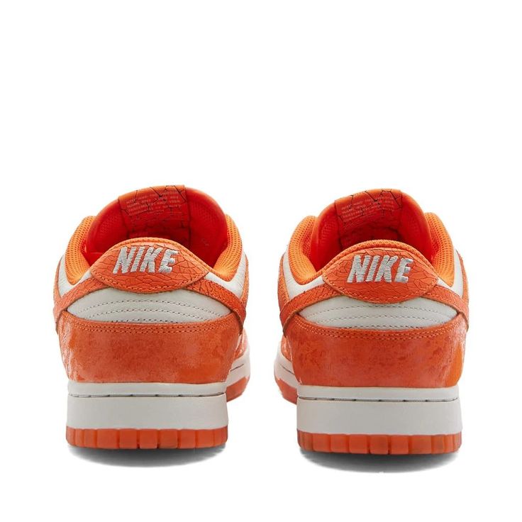 An icon in its own right in both the streetwear and skate spheres, Peter Moore’s legendary Nike Dunk low-tops now take on a vibrantly fresh perspective with this cracked orange pair. Here, the sportswear giant expertly experiments with texture; using a glossy patina across the tumbled leather uppers along the overlays - contrasted by a cracked effect across the signature sidewall Swooshes. It’s all complemented by the semi-translucent orange outsole that keeps the statement going, even underfoot Orange Athleisure Sneakers, Orange Adidas Logo Sneakers For Streetwear, Nike Orange Sneakers For Skateboarding, Orange Adidas Sneakers For Streetwear, Orange Nike Sneakers For Skateboarding, Orange Low-top Skate Shoes For Skateboarding, Nike Orange Skate Shoes For Streetwear, Urban Orange Sneakers For Skateboarding, Casual Orange Sneakers For Streetwear