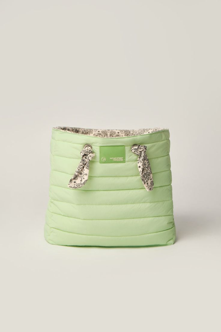 a green purse with two handles on it