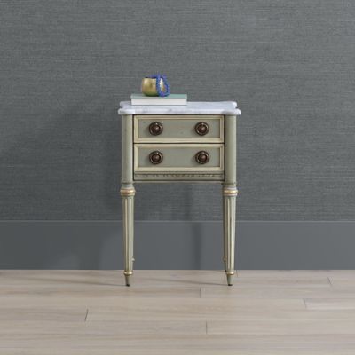 a small table with two drawers and a marble top in front of a gray wall