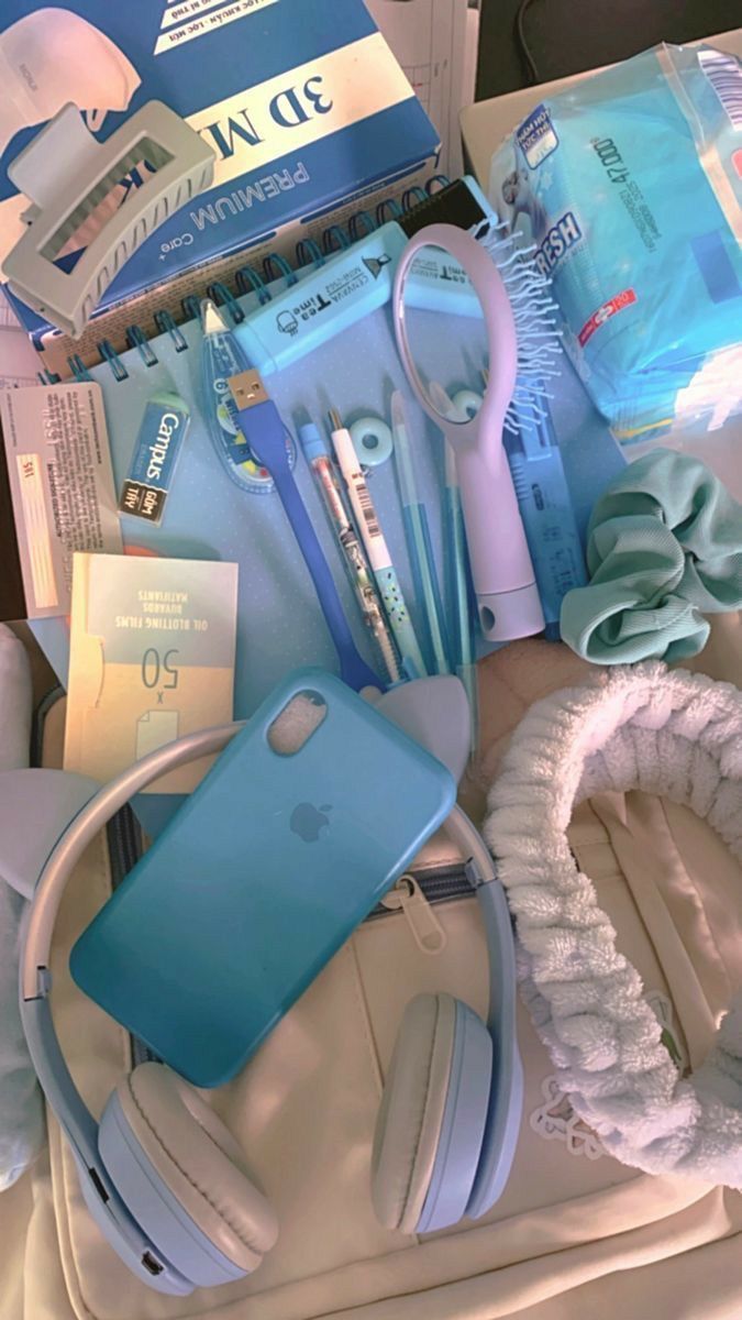 an assortment of items are displayed on a table with ear phones and headphones in the foreground