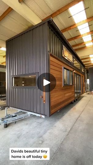 a tiny house made out of shipping containers in a building that is being built into the ground