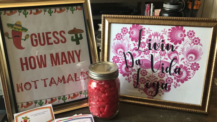 there are two framed pictures next to each other and some candy in a jar on the table