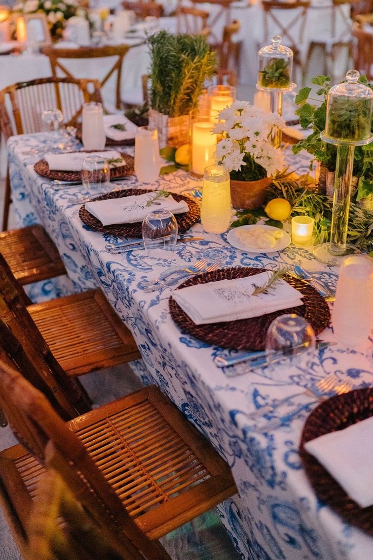 a table set with place settings and candles