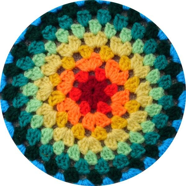 a colorful crochet pattern is shown in the middle of a circular shape, with an orange center surrounded by multicolored leaves