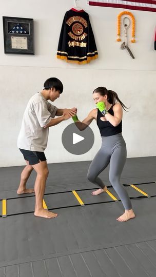 a man and woman standing on top of a gym floor