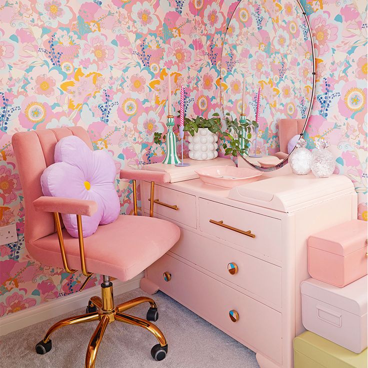 a pink desk chair sitting next to a dresser with a mirror on top of it