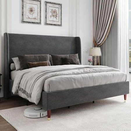 a bedroom with a bed, nightstands and window in the background on a white rug