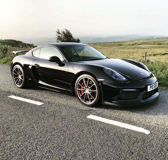 a black sports car is parked on the side of the road